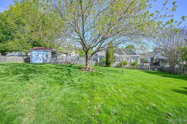 view of yard featuring an outdoor structure and a fenced backyard