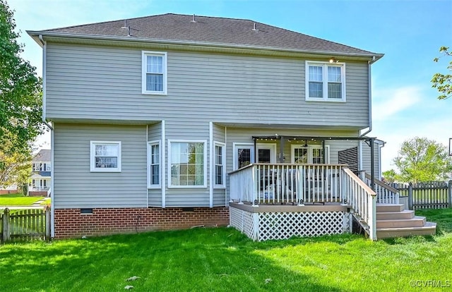 back of property featuring fence, a yard, crawl space, and a deck