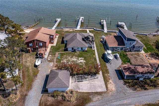 drone / aerial view with a water view and a residential view