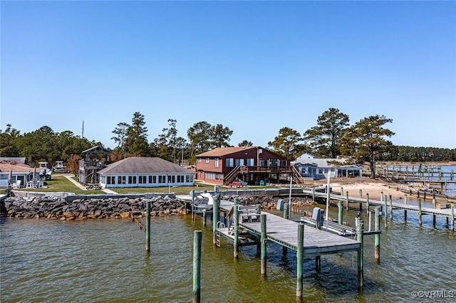 dock area featuring boat lift and a water view