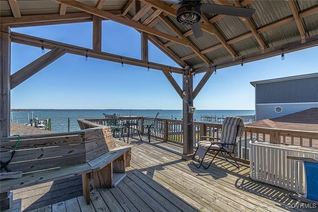 deck featuring a ceiling fan and a water view
