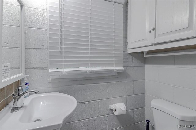 half bath with toilet and a sink
