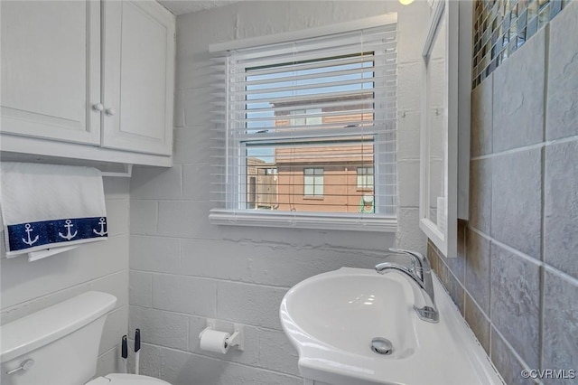 bathroom with toilet and a sink
