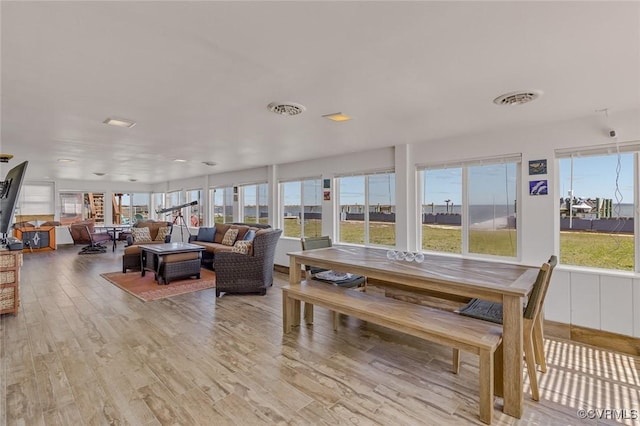 sunroom / solarium featuring visible vents and a healthy amount of sunlight