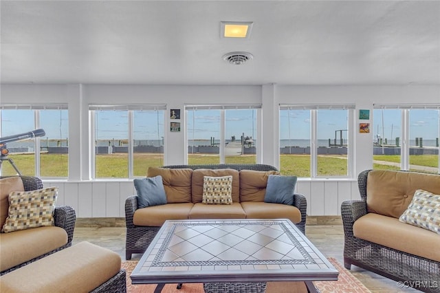 sunroom featuring a healthy amount of sunlight and visible vents
