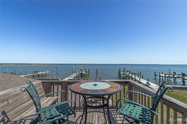 deck with a dock and a water view