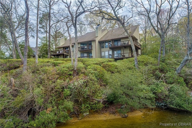 back of property featuring a chimney