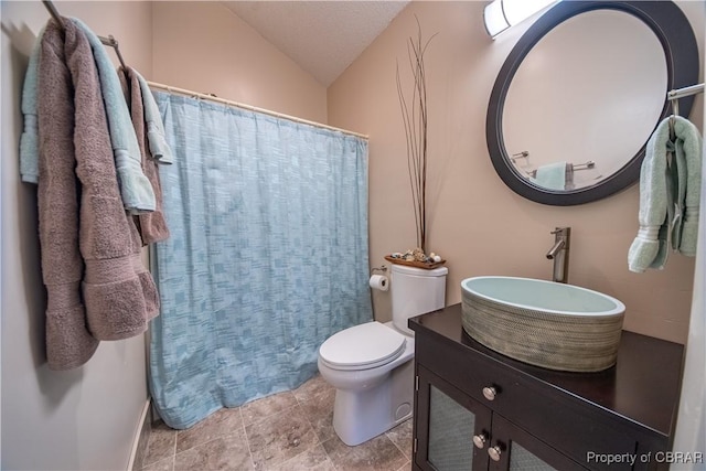 full bathroom featuring curtained shower, lofted ceiling, toilet, and vanity