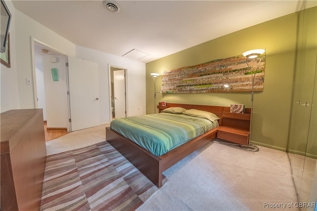 carpeted bedroom featuring visible vents and baseboards