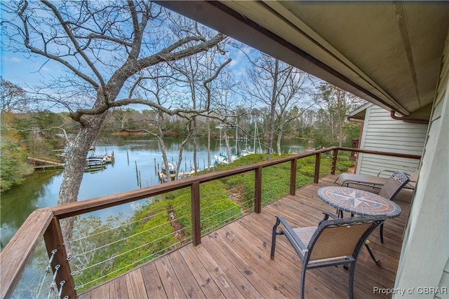 wooden deck featuring a water view