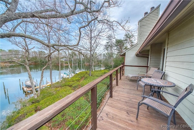 wooden deck featuring a water view