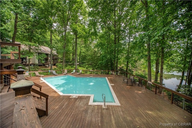 community pool featuring a deck with water view