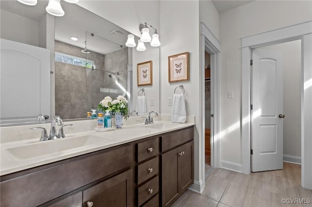 5530 Tyshire Pkwy, Providence Forge, VA 23140 - bathroom with a tile shower, double vanity, tile patterned flooring, and baseboards