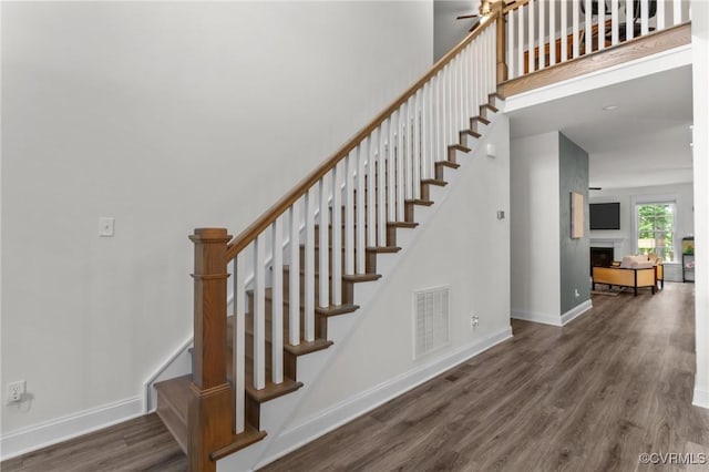 5530 Tyshire Pkwy, Providence Forge, VA 23140 - stairway featuring wood finished floors, a fireplace, and baseboards