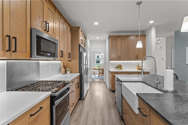 5530 Tyshire Pkwy, Providence Forge, VA 23140 - kitchen with appliances with stainless steel finishes, a sink, light wood-style flooring, brown cabinets, and recessed lighting