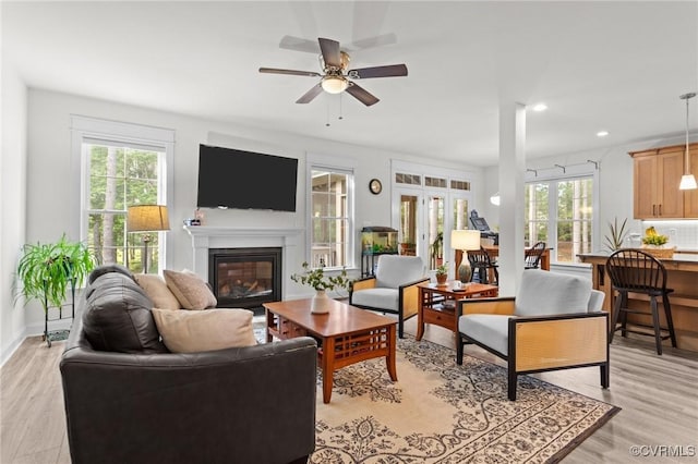 5530 Tyshire Pkwy, Providence Forge, VA 23140 - living area with healthy amount of natural light, a glass covered fireplace, ceiling fan, light wood finished floors, and recessed lighting