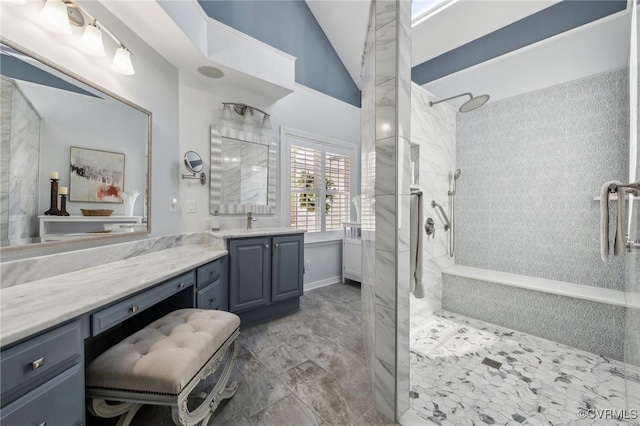 bathroom with vaulted ceiling, walk in shower, and vanity