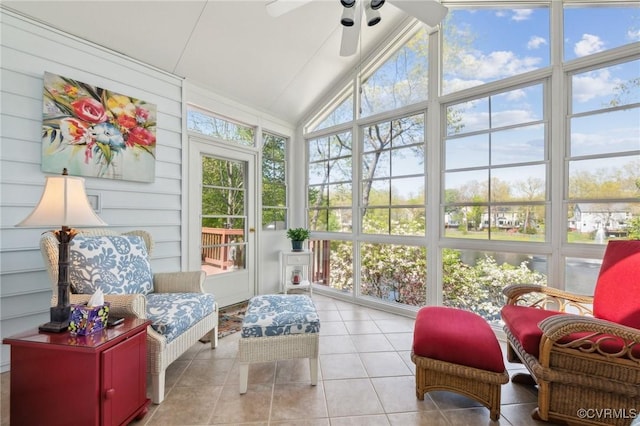 sunroom featuring high vaulted ceiling, a ceiling fan, and tile patterned flooring