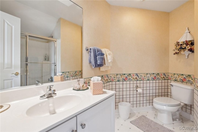 full bathroom with toilet, wainscoting, tile walls, a shower stall, and vanity