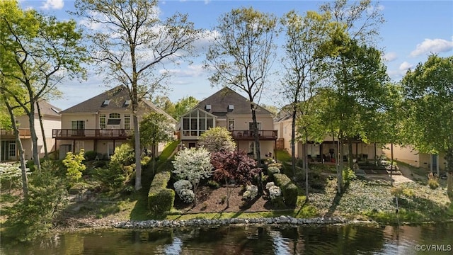exterior space with a deck with water view
