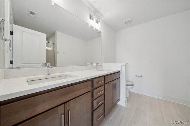 12129 Morning Walk, Henrico, VA 23233 - full bathroom featuring double vanity, toilet, a shower with shower door, and baseboards