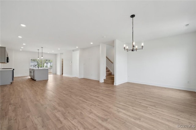 12129 Morning Walk, Henrico, VA 23233 - unfurnished living room with recessed lighting, light wood-style flooring, a chandelier, stairs, and a sink
