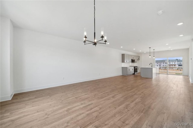 12129 Morning Walk, Henrico, VA 23233 - unfurnished living room with a chandelier, recessed lighting, light wood-type flooring, a sink, and baseboards