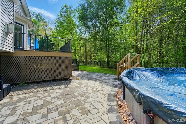 view of patio / terrace with stairs, fence, a wooden deck, and a fenced in pool