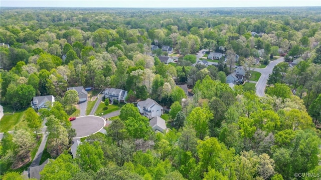 bird's eye view featuring a residential view and a wooded view