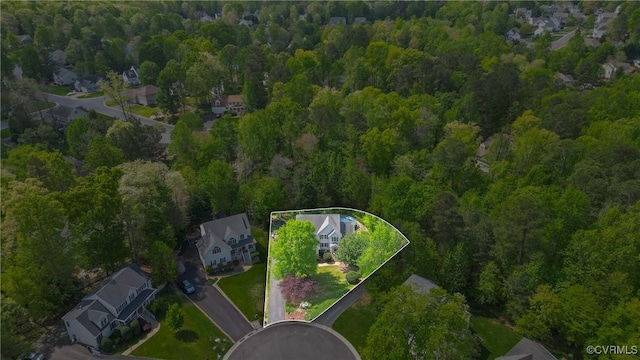 birds eye view of property featuring a residential view and a view of trees