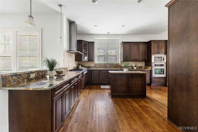 1300 Baltrey Ln, Midlothian, VA 23112 - kitchen with appliances with stainless steel finishes, healthy amount of natural light, wall chimney exhaust hood, dark wood-type flooring, and recessed lighting