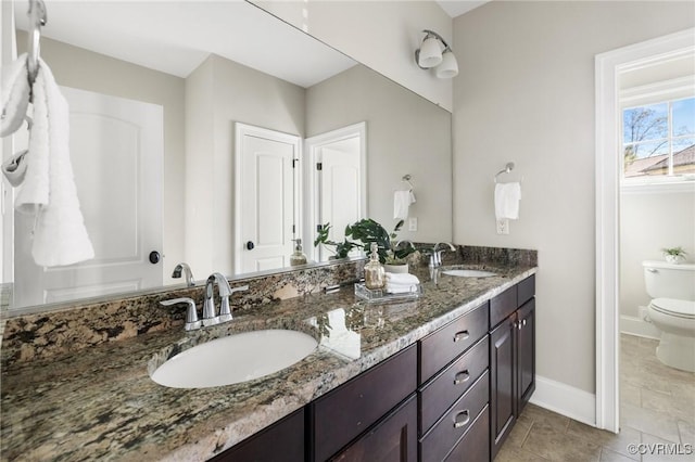 1300 Baltrey Ln, Midlothian, VA 23112 - bathroom with toilet, double vanity, tile patterned flooring, and baseboards