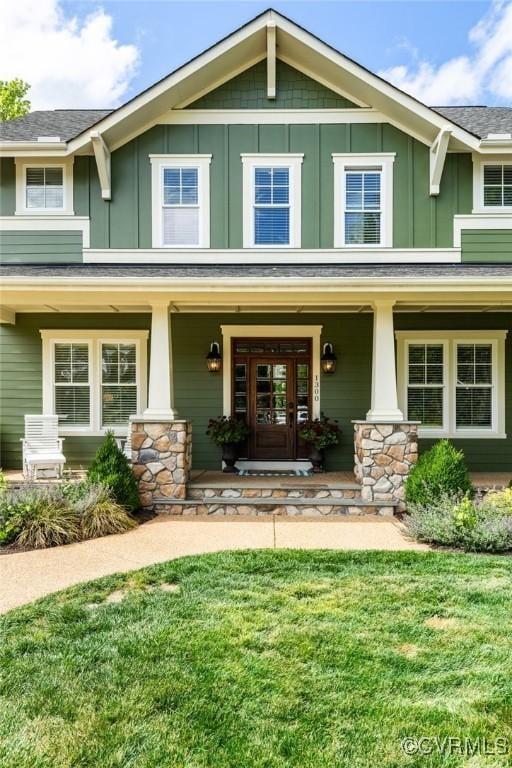1300 Baltrey Ln, Midlothian, VA 23112 - craftsman house featuring board and batten siding, a porch, stone siding, and a front yard