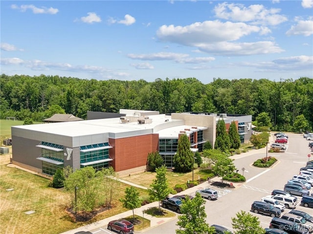 drone / aerial view featuring a forest view