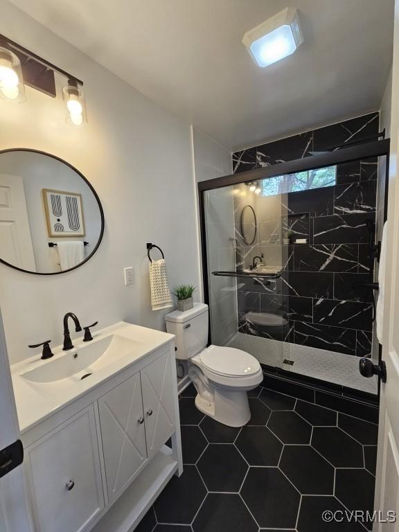 3109 Comet Rd, Richmond, VA 23294 - bathroom with toilet, a shower stall, tile patterned flooring, and vanity