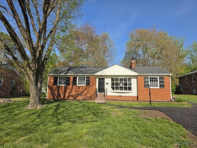 3109 Comet Rd, Richmond, VA 23294 - view of front of home featuring brick siding, a chimney, and a front lawn