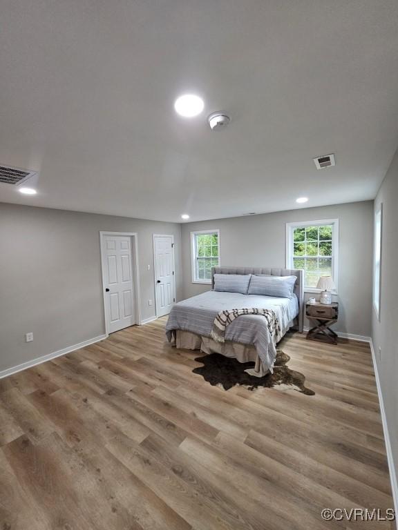 3109 Comet Rd, Richmond, VA 23294 - bedroom featuring baseboards, multiple windows, wood finished floors, and visible vents