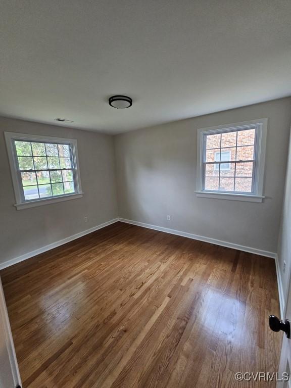 3109 Comet Rd, Richmond, VA 23294 - empty room with plenty of natural light, baseboards, and dark wood-style floors