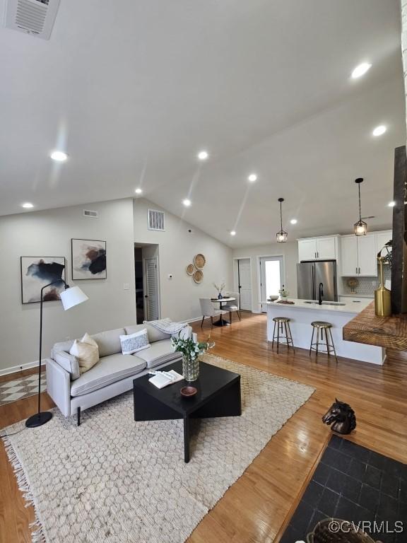 3109 Comet Rd, Richmond, VA 23294 - living room featuring lofted ceiling, wood finished floors, and visible vents