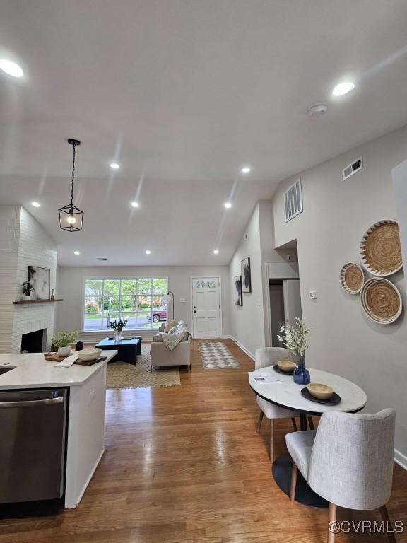 3109 Comet Rd, Richmond, VA 23294 - interior space featuring stainless steel dishwasher, visible vents, wood finished floors, open floor plan, and vaulted ceiling