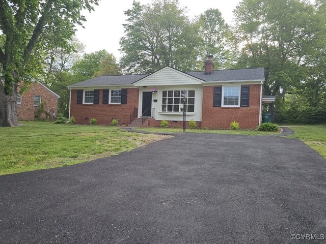 3109 Comet Rd, Richmond, VA 23294 - view of front of home featuring a chimney, a front yard, driveway, and brick siding