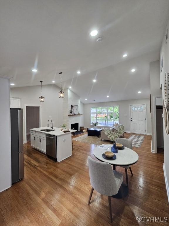 3109 Comet Rd, Richmond, VA 23294 - kitchen featuring vaulted ceiling, dishwasher, a sink, freestanding refrigerator, and open floor plan