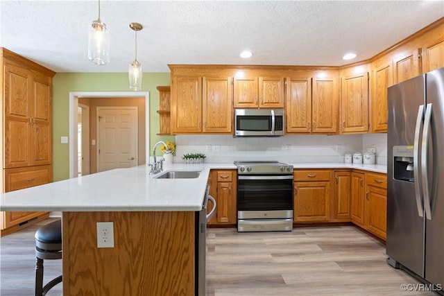 106 Kennon Pointe Ct, Colonial Heights, VA 23834 - kitchen featuring appliances with stainless steel finishes, a peninsula, light countertops, light wood-style flooring, and open shelves