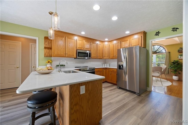 106 Kennon Pointe Ct, Colonial Heights, VA 23834 - kitchen with stainless steel appliances, a peninsula, light wood-style floors, open shelves, and a breakfast bar