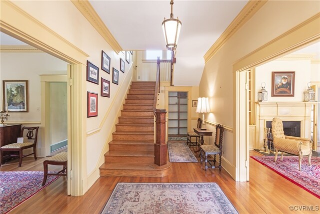 1731 Westover Ave, Petersburg, VA 23805 - staircase with hardwood / wood-style floors, a fireplace, and crown molding