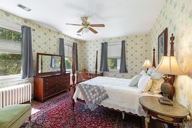 1731 Westover Ave, Petersburg, VA 23805 - bedroom featuring radiator heating unit, wallpapered walls, multiple windows, and wood finished floors