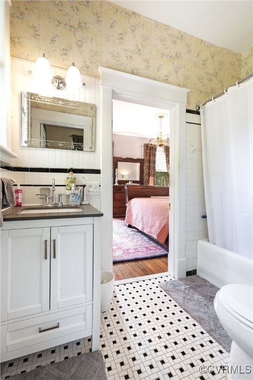 1731 Westover Ave, Petersburg, VA 23805 - bathroom with wallpapered walls, toilet, vanity, connected bathroom, and a chandelier