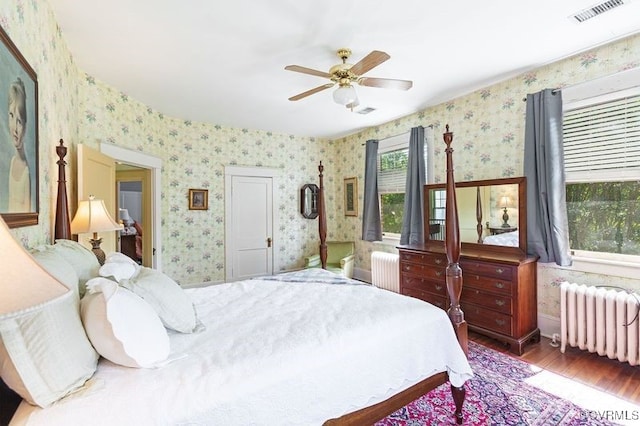1731 Westover Ave, Petersburg, VA 23805 - bedroom featuring radiator heating unit, wallpapered walls, wood finished floors, and a ceiling fan