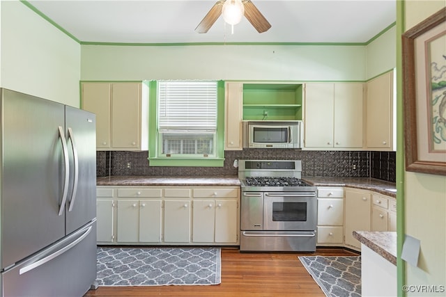 1731 Westover Ave, Petersburg, VA 23805 - kitchen with stainless steel appliances, cream cabinets, wood finished floors, a ceiling fan, and crown molding