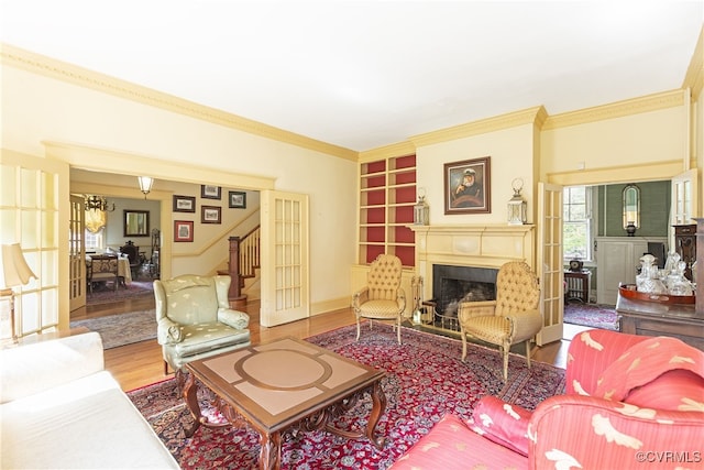 1731 Westover Ave, Petersburg, VA 23805 - living area with wood finished floors, a fireplace, crown molding, stairway, and built in shelves